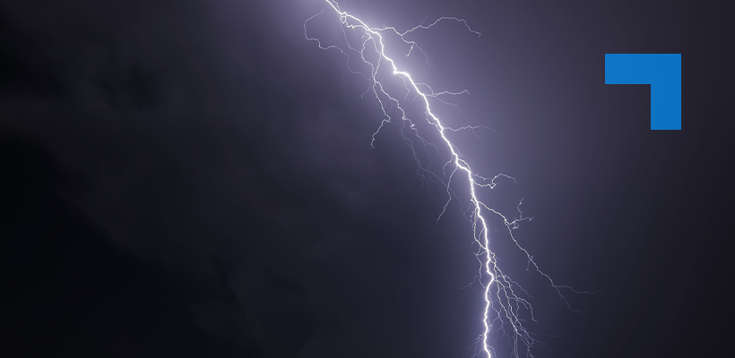 A bolt of lightning illuminates a dark sky.