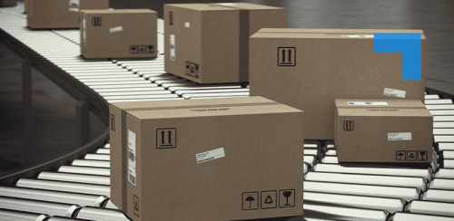Cardboard shipping boxes of various sizes moving along a curved conveyor belt in a warehouse distribution centre.