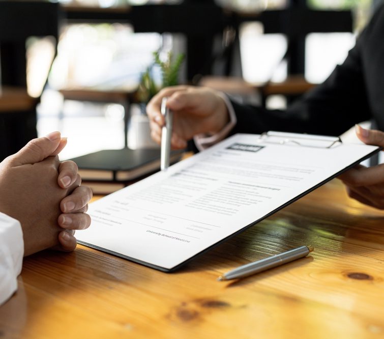 Business owner reviewing documents as part of a recruitment business sale