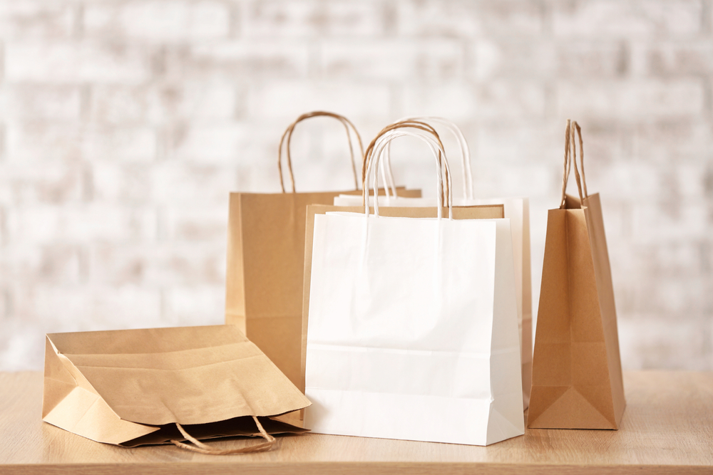 Retail shopping bags displayed in a store environment, representing retail and consumer goods businesses