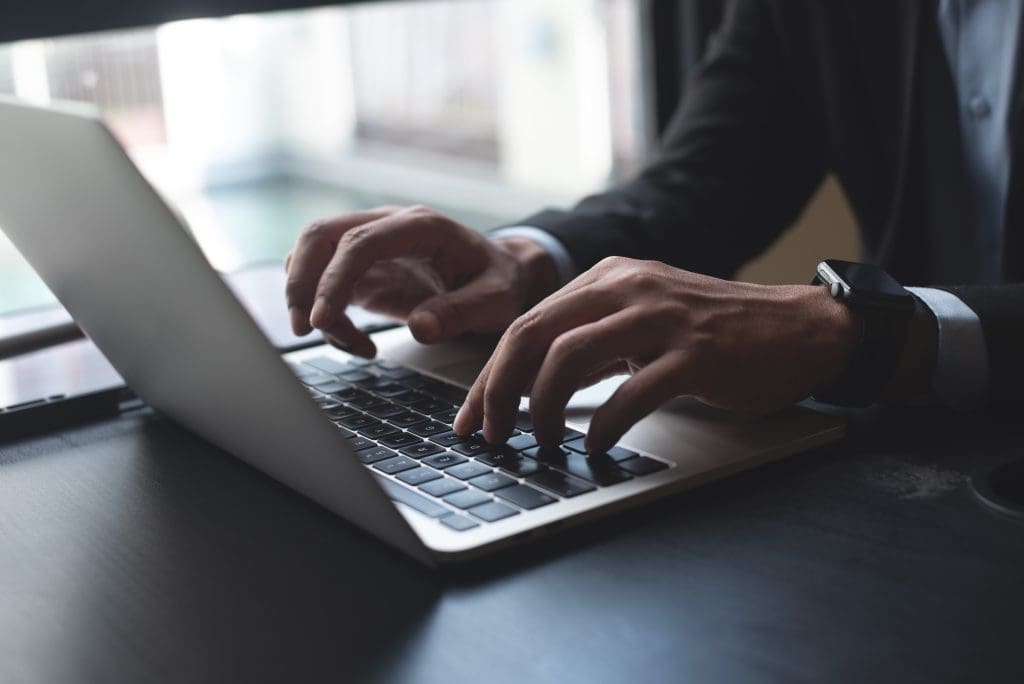 Closeup of businessman's hands typing